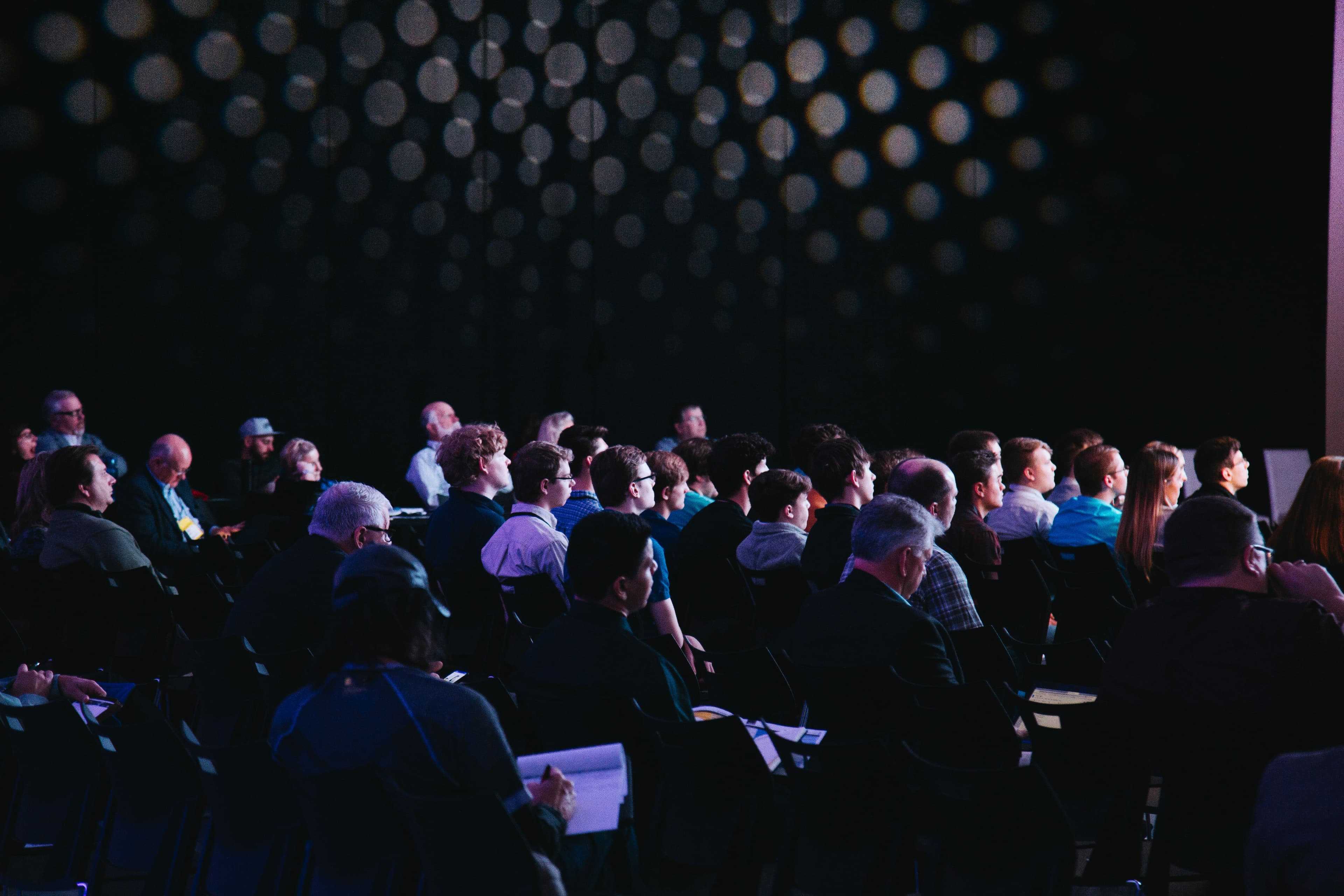 An attentive audience seated at an evening event