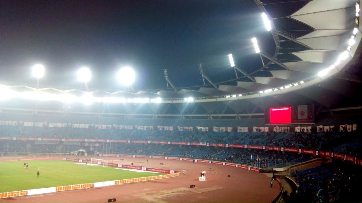 Floodlights over the stands and track of Jawaharlal Nehru Stadium at night