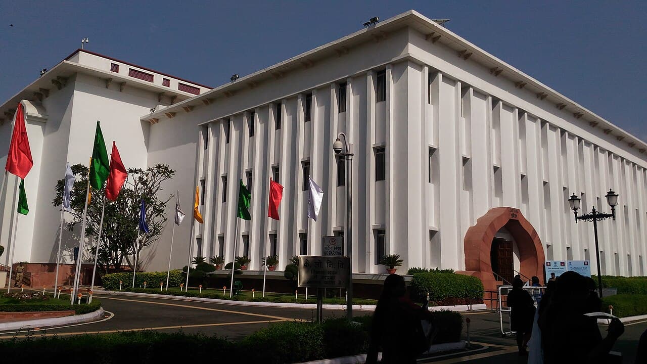The white colonnaded façade of Vigyan Bhawan lined with flagpoles